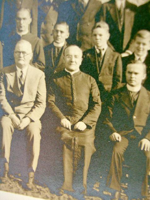 Fr. Aloysius is seated in the center.